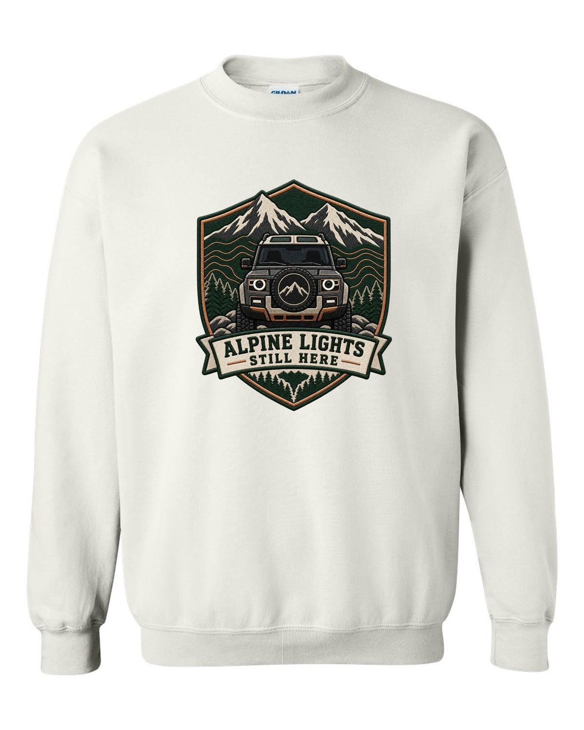 Original shield crest print for a Land Rover Defender L663 with Alpine Lights Still Here text white crewneck front view with the design