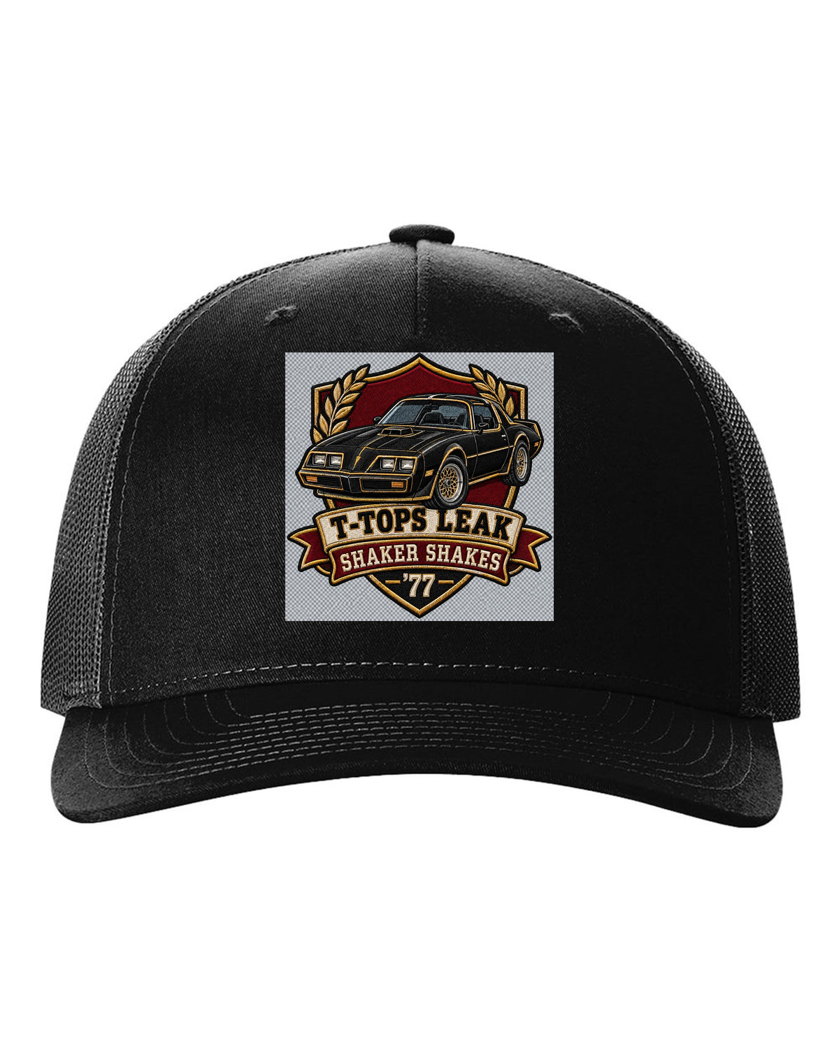 Varsity crest print for a 1977 Pontiac Firebird Trans Am with the text T-Tops Leak, Shaker Shakes, '77 black hat front view with the design