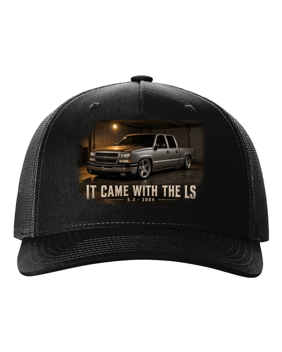 2004 Chevy Silverado crew cab in a garage night scene, print black hat front view with the design