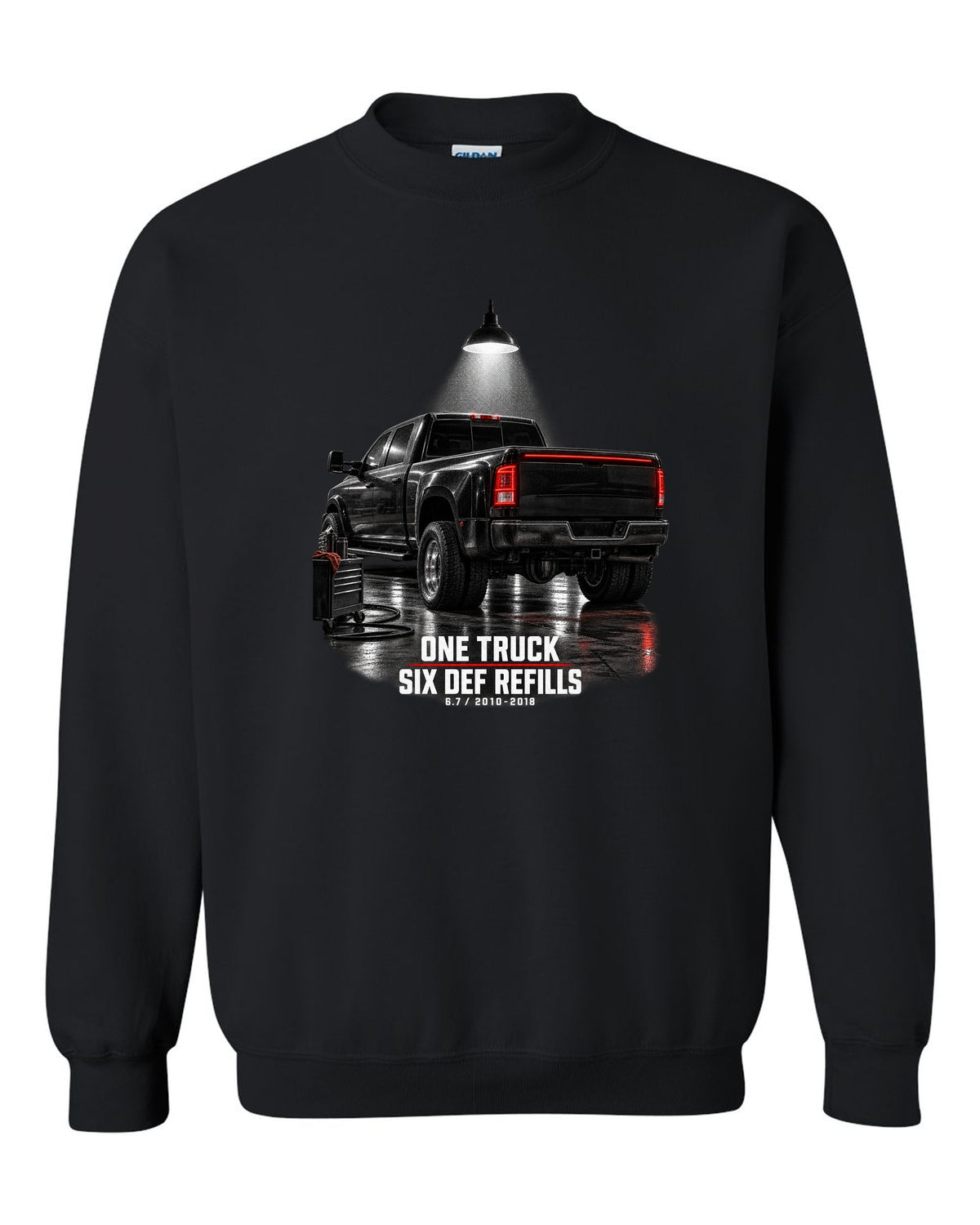 Ram 3500 4th gen dually 6.7 in a night garage with the text One truck, six DEF refills black crewneck front view with the design