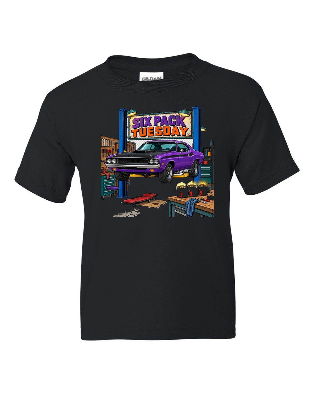 Garage workshop scene with a 1970 Dodge Challenger T/A on a lift and Six Pack Tuesday text black kids tee front view with the design
