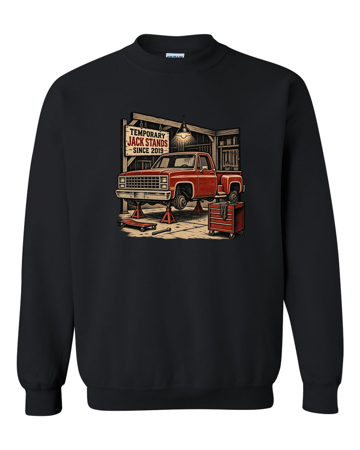 Linocut woodcut style print of a 1973-87 Chevrolet C10 Squarebody Stepside in a workshop with jack stands lettering black crewneck front view with the design