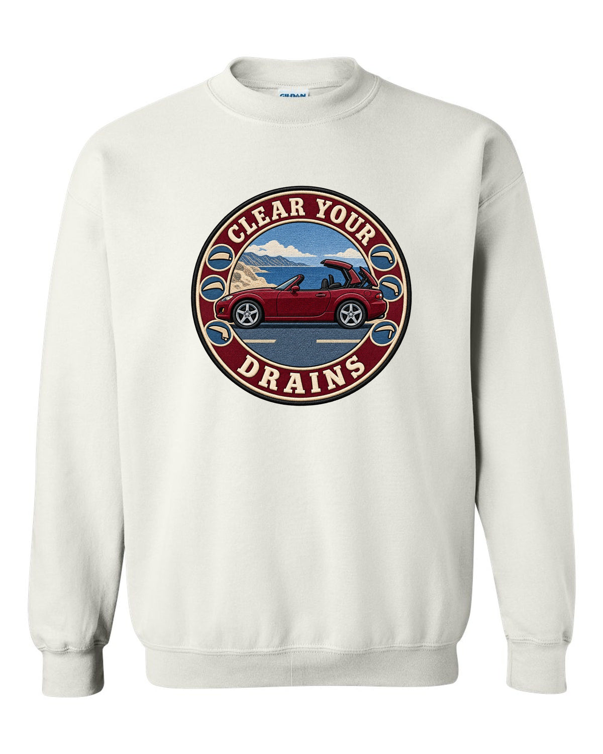 Embroidery-style roundel crest of a Mazda MX-5 NC with clear your drains text white crewneck front view with the design