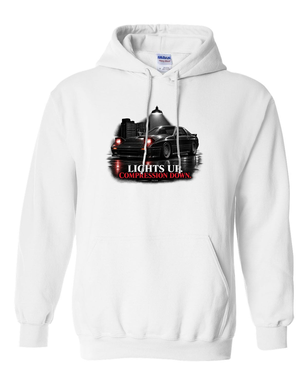 Low front three-quarter Mazda RX-7 FC3S Turbo II in a garage at night white pull over hoodie front view with the design
