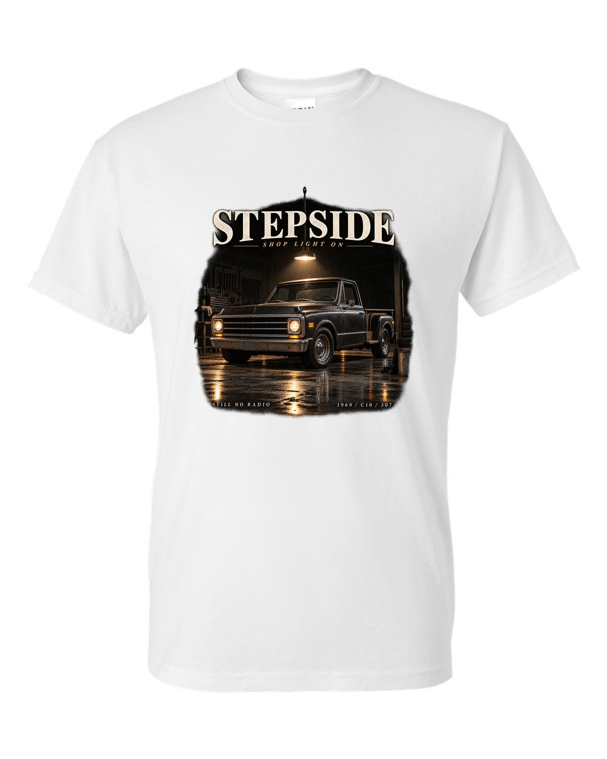 Chevy C10 Stepside under a shop light, garage night print white t-shirt front view with the design