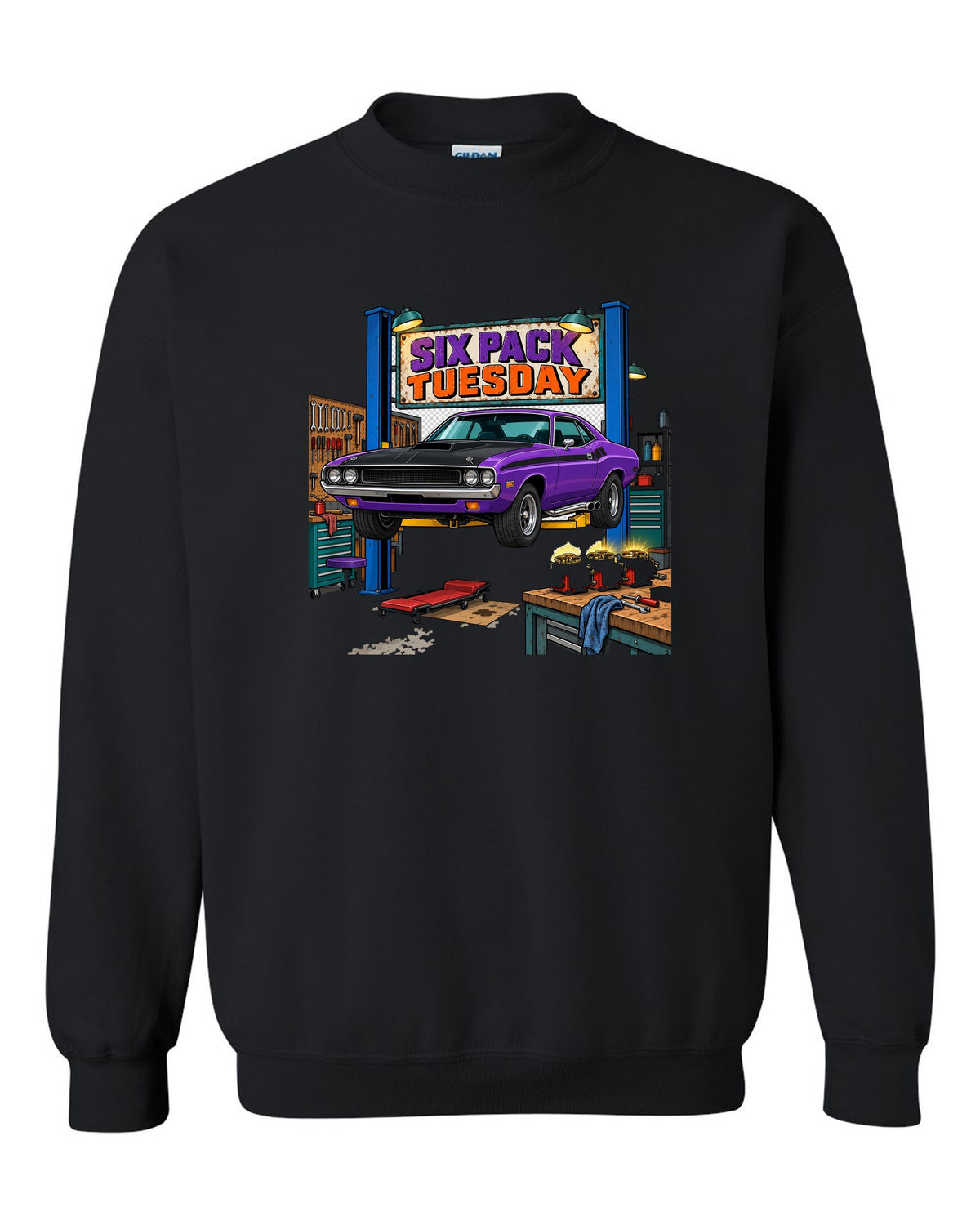 Garage workshop scene with a 1970 Dodge Challenger T/A on a lift and Six Pack Tuesday text black crewneck front view with the design