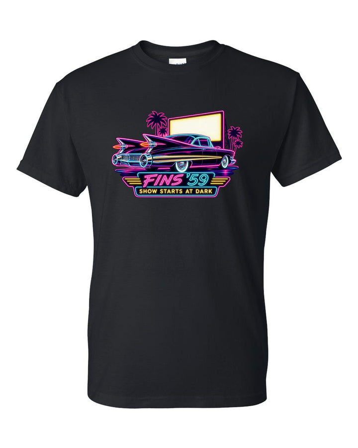 1959 Cadillac Coupe de Ville under neon sign glow at a night drive-in black t-shirt front view with the design