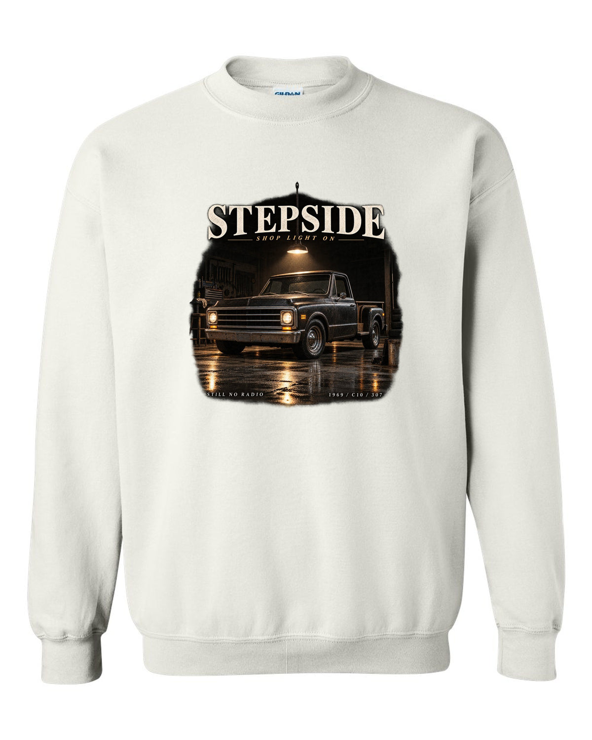 Chevy C10 Stepside under a shop light, garage night print white crewneck front view with the design