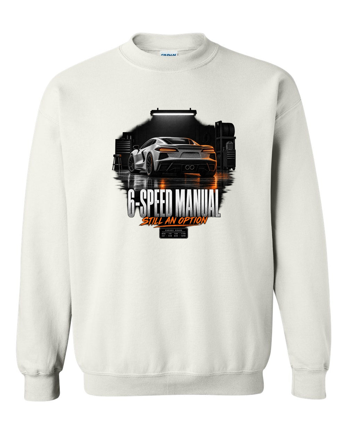 Lotus Emira V6 in a garage at night with 6-speed manual text white crewneck front view with the design