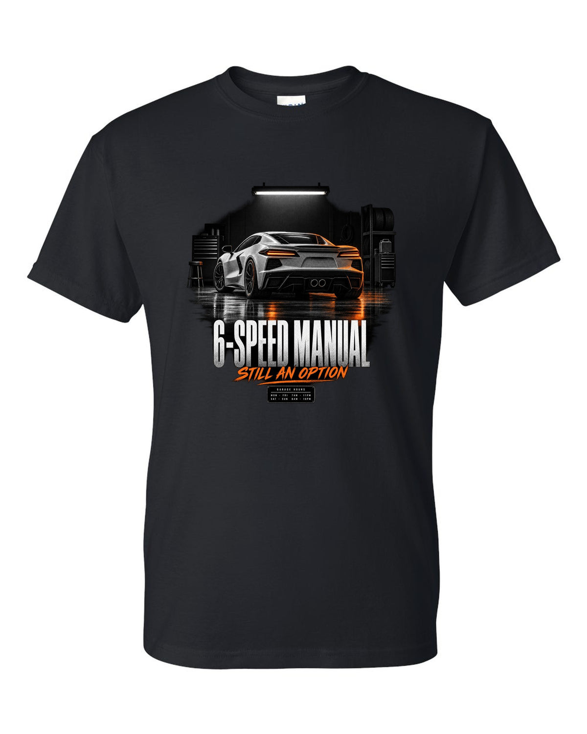 Lotus Emira V6 in a garage at night with 6-speed manual text black t-shirt front view with the design