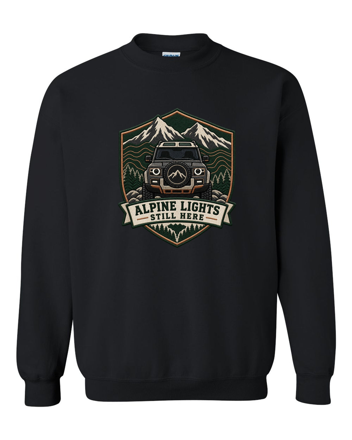 Original shield crest print for a Land Rover Defender L663 with Alpine Lights Still Here text black crewneck front view with the design