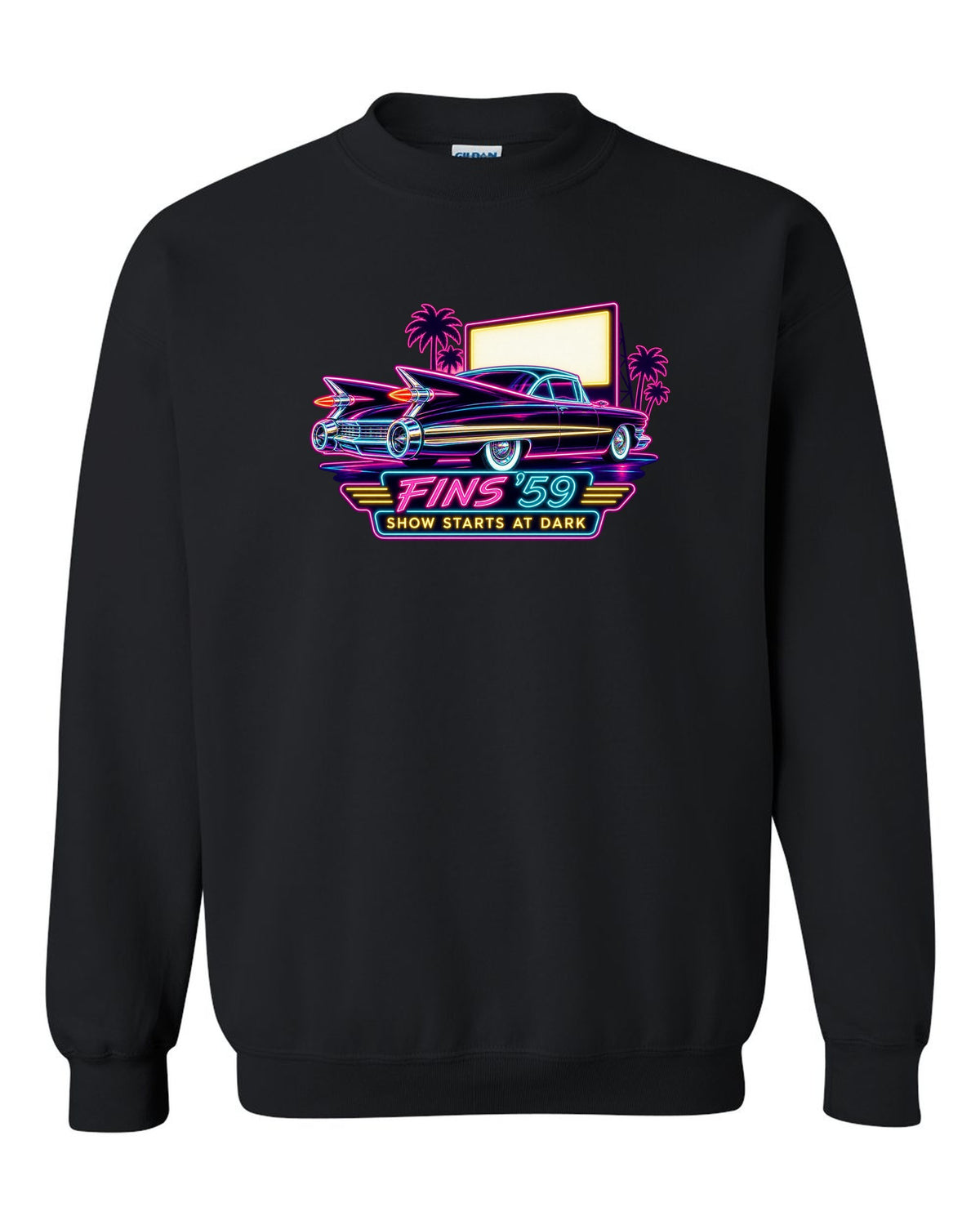 1959 Cadillac Coupe de Ville under neon sign glow at a night drive-in black crewneck front view with the design
