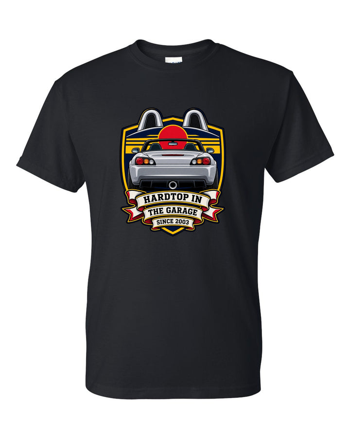 Embroidery patch style print of a 1999 Honda S2000 AP1 roadster with hardtop in the garage text black t-shirt front view with the design