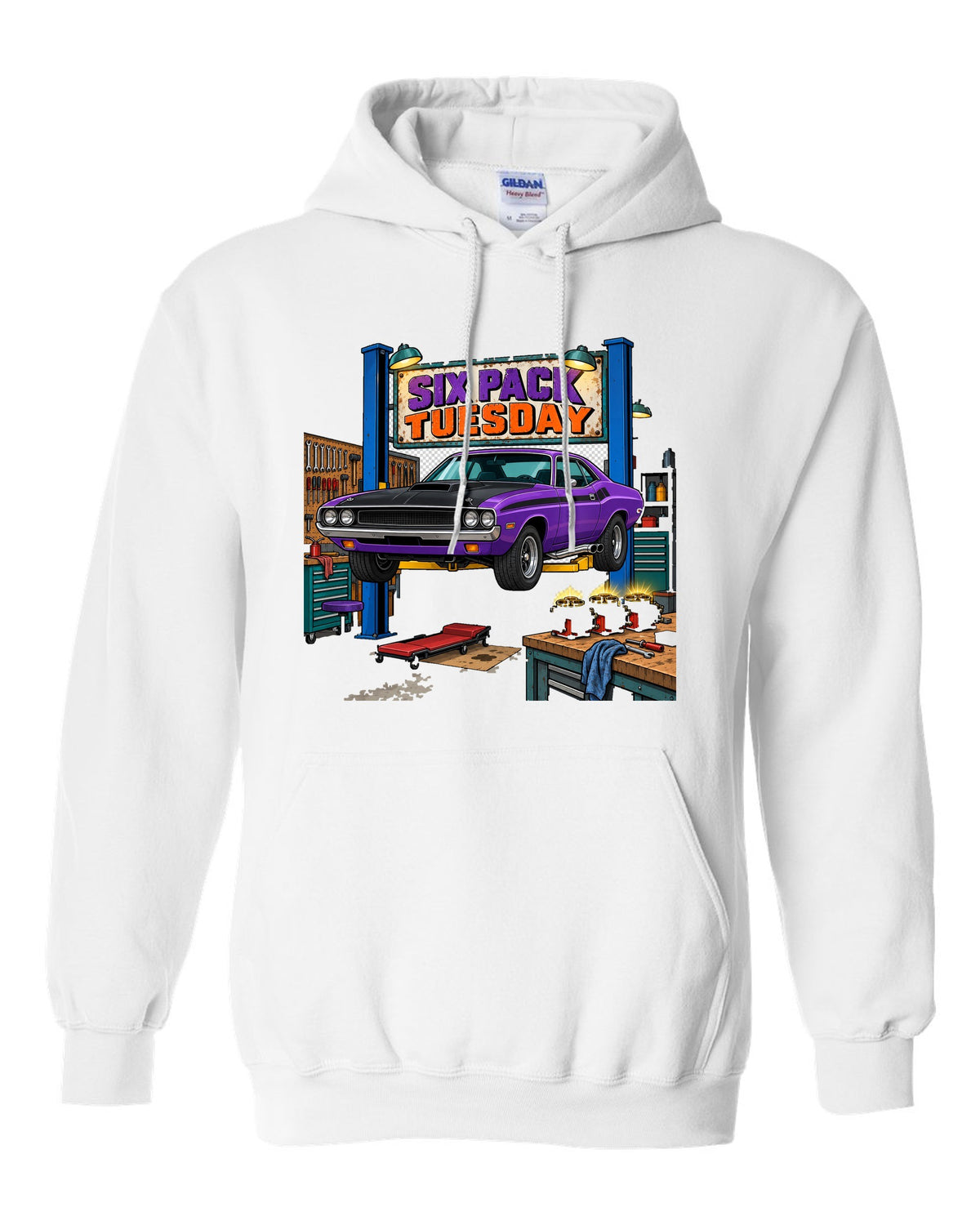 Garage workshop scene with a 1970 Dodge Challenger T/A on a lift and Six Pack Tuesday text white pull over hoodie front view with the design