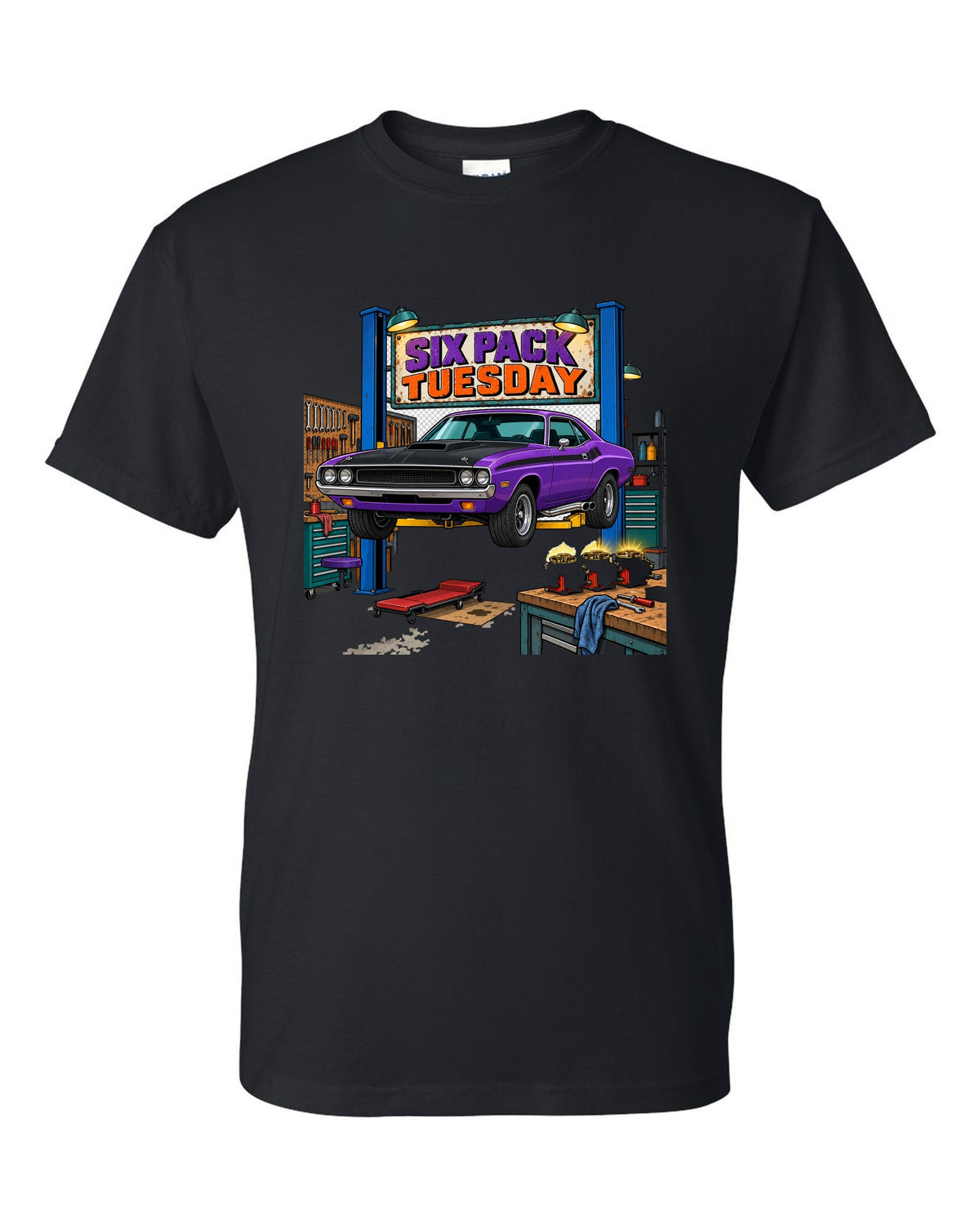 Garage workshop scene with a 1970 Dodge Challenger T/A on a lift and Six Pack Tuesday text black t-shirt front view with the design