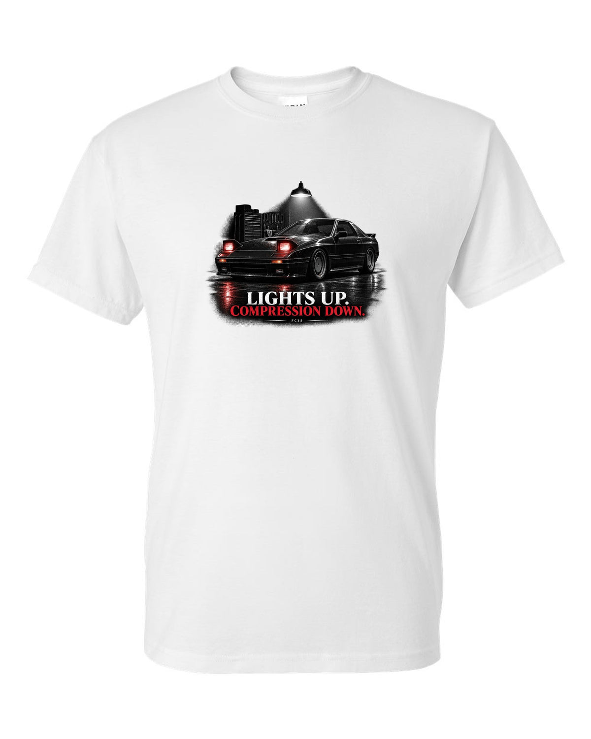 Low front three-quarter Mazda RX-7 FC3S Turbo II in a garage at night white t-shirt front view with the design