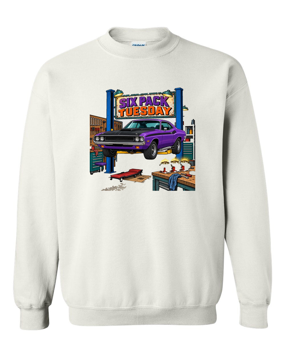Garage workshop scene with a 1970 Dodge Challenger T/A on a lift and Six Pack Tuesday text white crewneck front view with the design