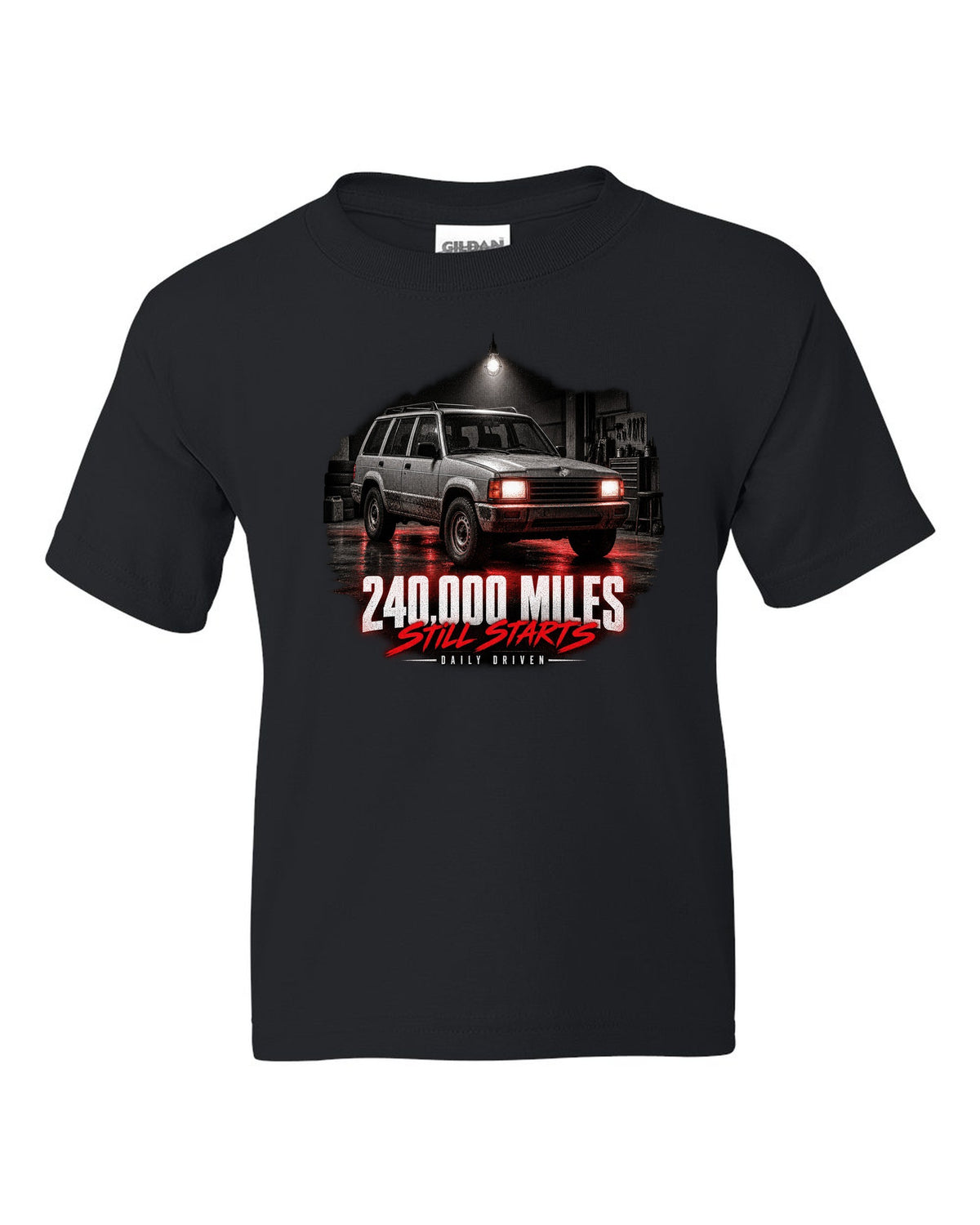 Jeep Cherokee XJ at night with daily driven 240,000 miles print black kids tee front view with the design