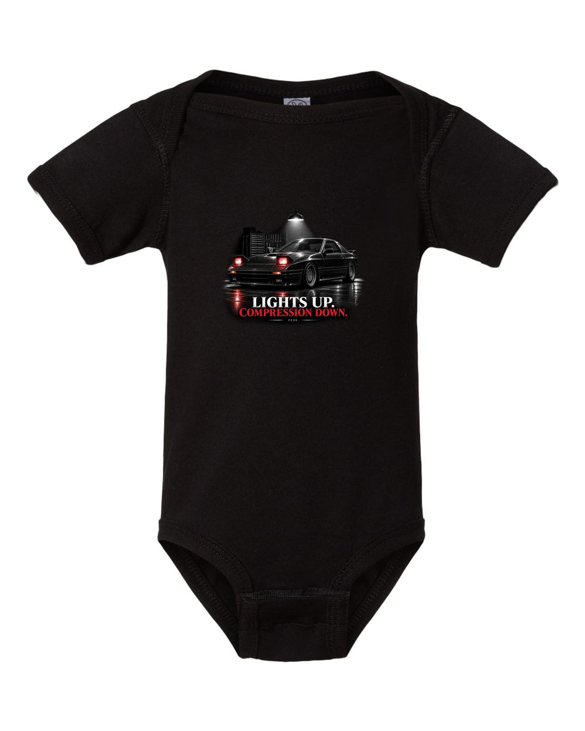 Low front three-quarter Mazda RX-7 FC3S Turbo II in a garage at night black baby onesie front view with the design
