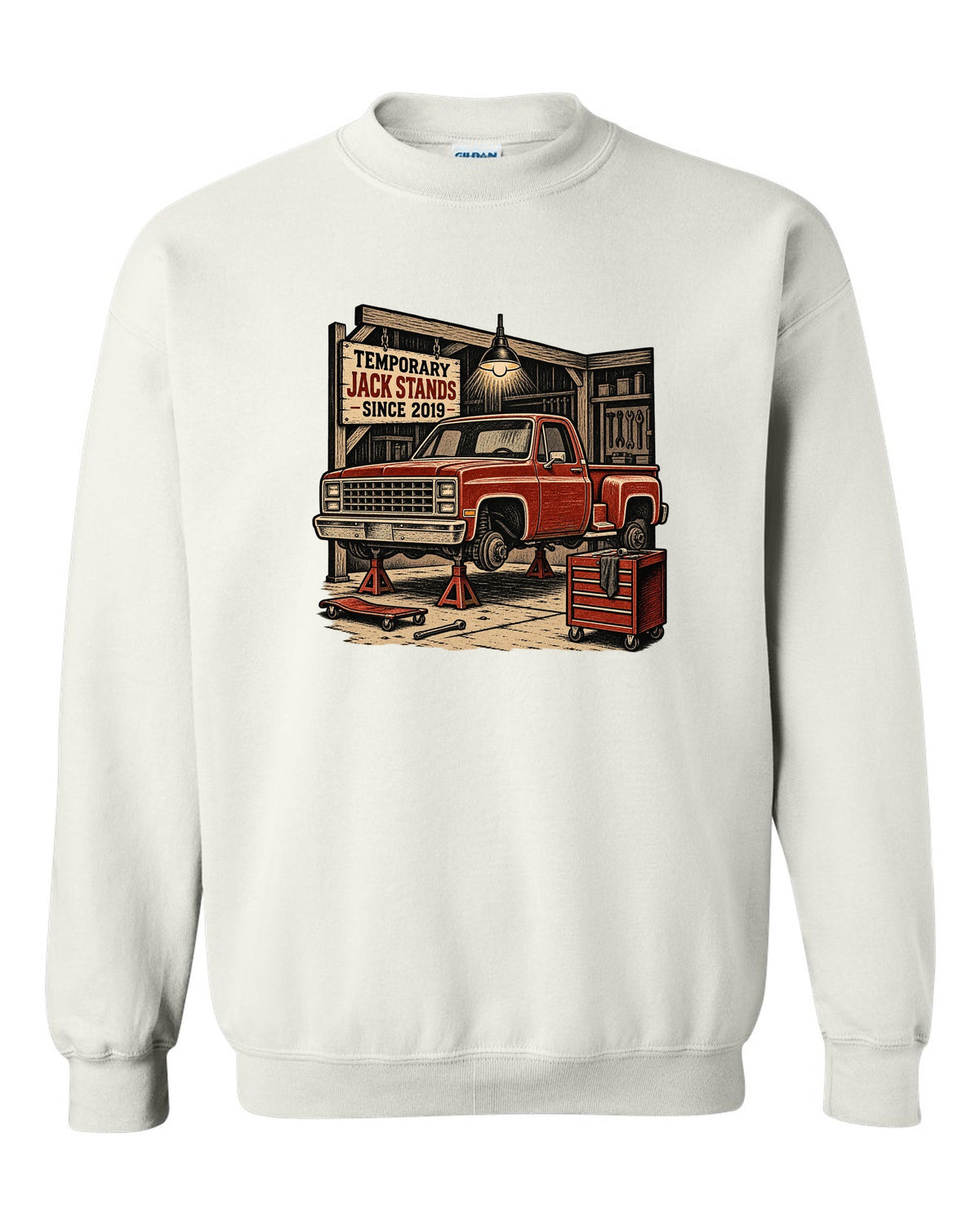 Linocut woodcut style print of a 1973-87 Chevrolet C10 Squarebody Stepside in a workshop with jack stands lettering white crewneck front view with the design