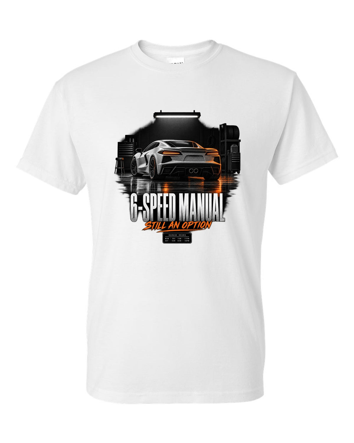 Lotus Emira V6 in a garage at night with 6-speed manual text white t-shirt front view with the design