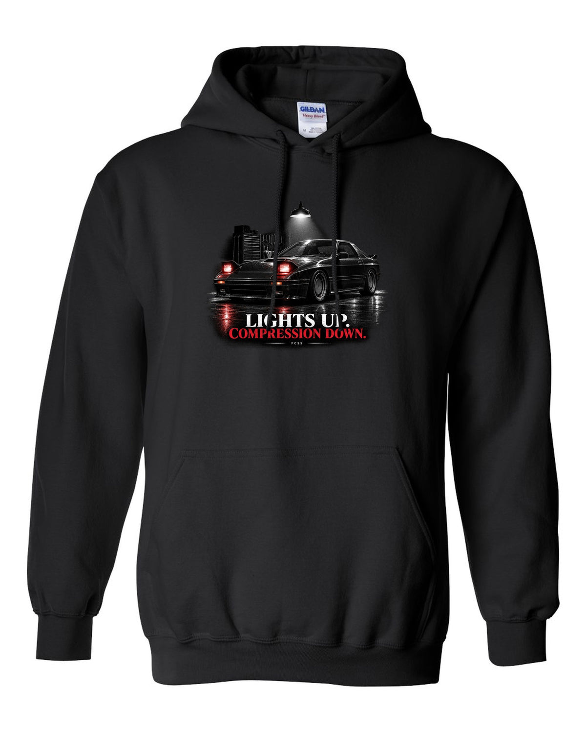 Low front three-quarter Mazda RX-7 FC3S Turbo II in a garage at night black pull over hoodie front view with the design