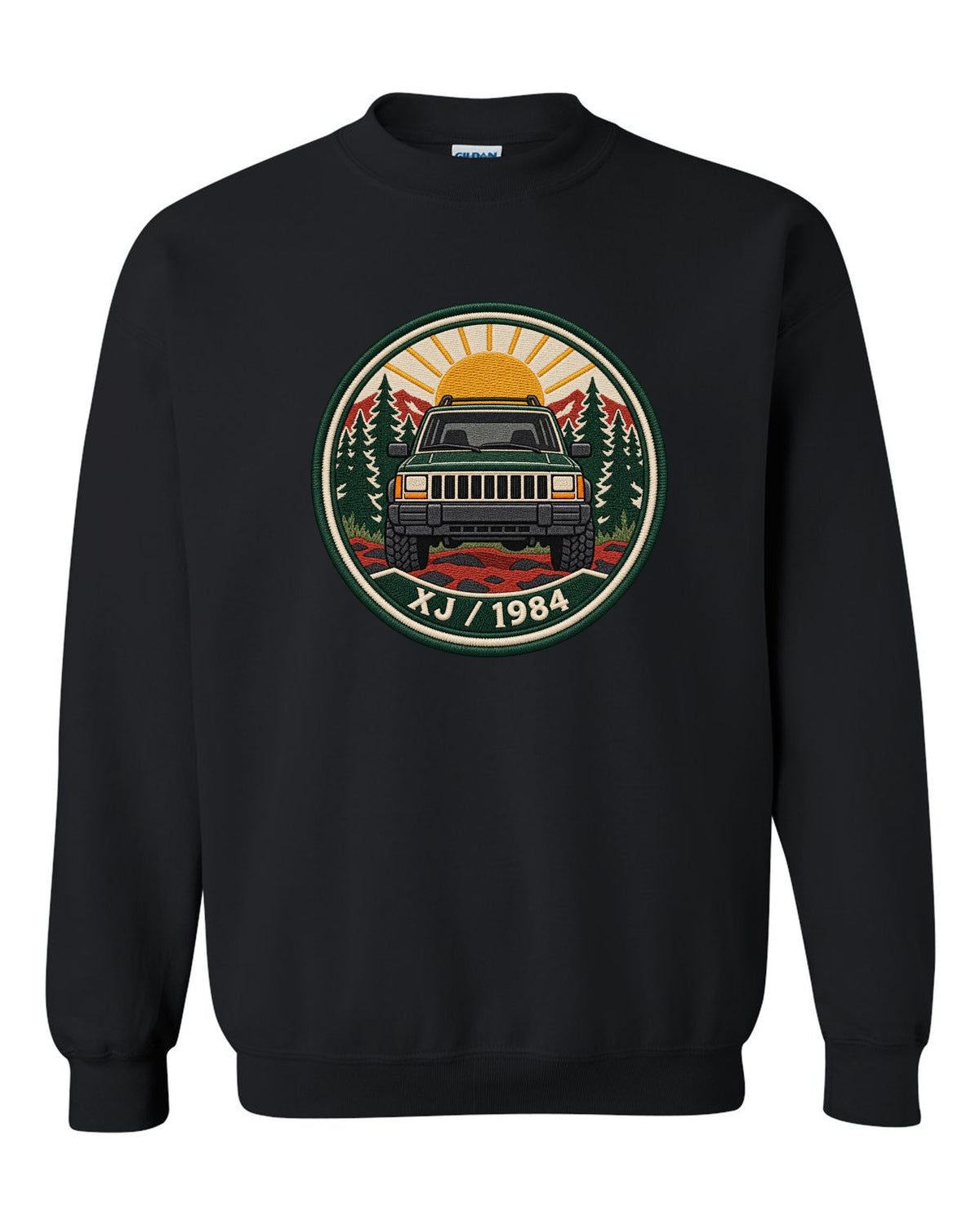 Round embroidered-style crest print of a boxy Jeep Cherokee XJ with XJ 1984 text black crewneck front view with the design