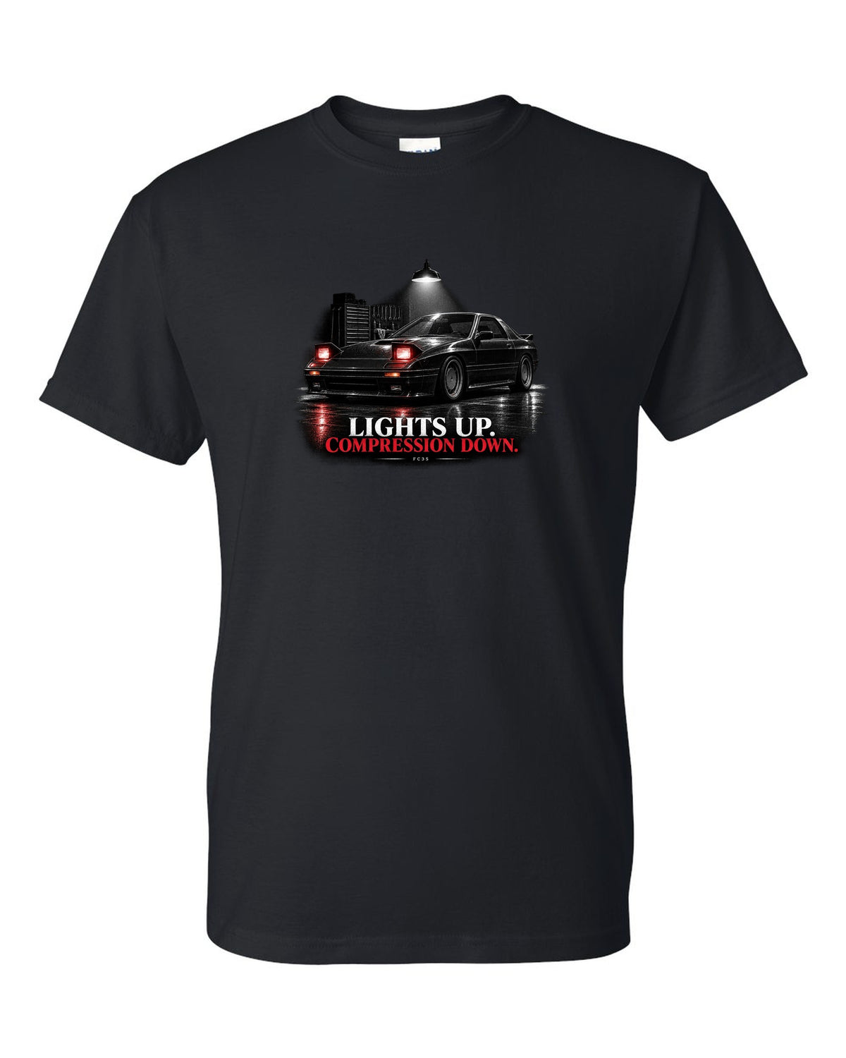 Low front three-quarter Mazda RX-7 FC3S Turbo II in a garage at night black t-shirt front view with the design