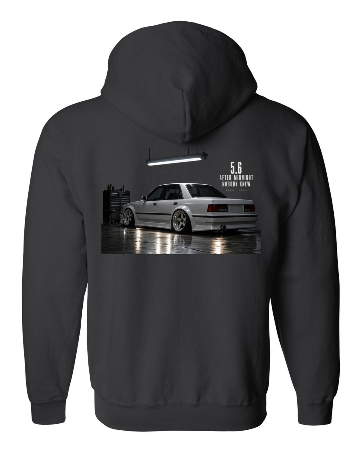 print of a Mercedes W124 300E 5.6 Hammer in a night garage with the text 5.6 After Midnight Nobody Knew black zip hoodie back view with the design