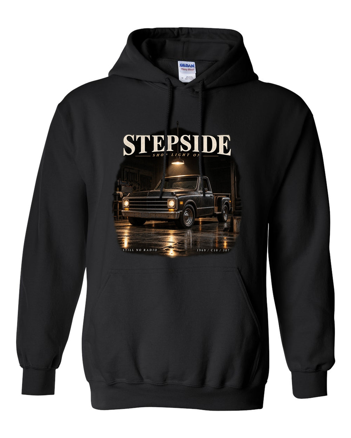 Chevy C10 Stepside under a shop light, garage night print black pull over hoodie front view with the design