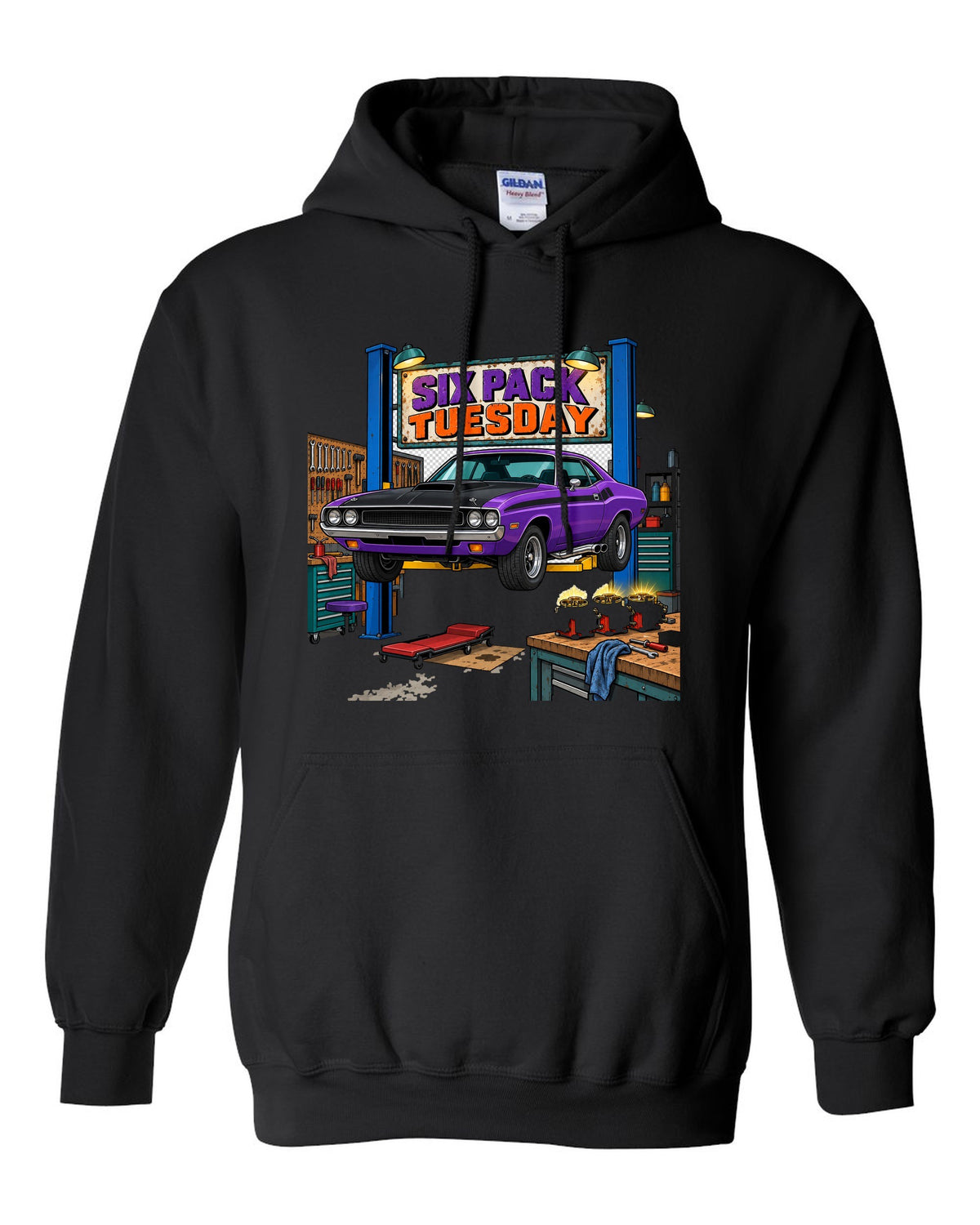 Garage workshop scene with a 1970 Dodge Challenger T/A on a lift and Six Pack Tuesday text black pull over hoodie front view with the design