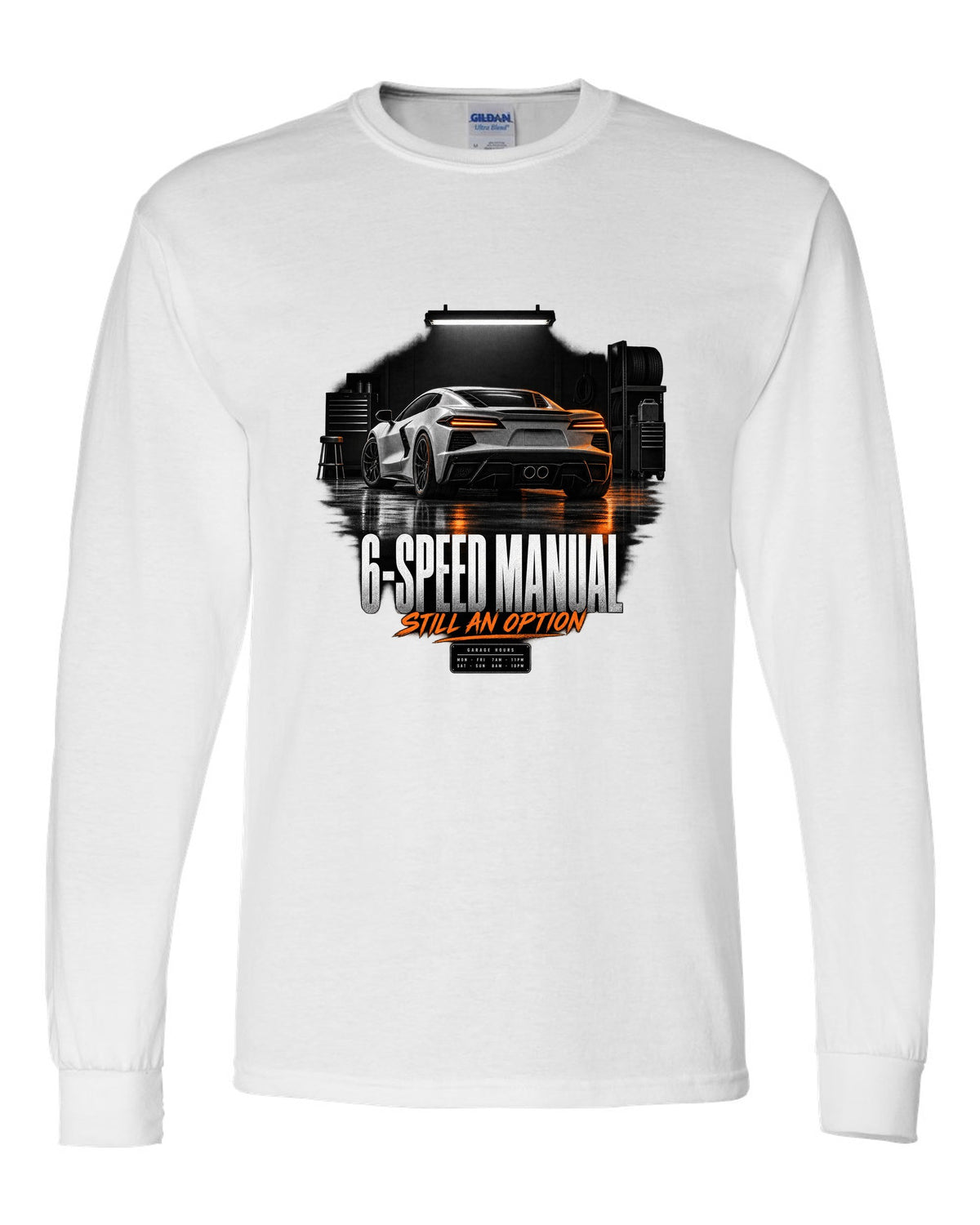 Lotus Emira V6 in a garage at night with 6-speed manual text white long sleeve front view with the design