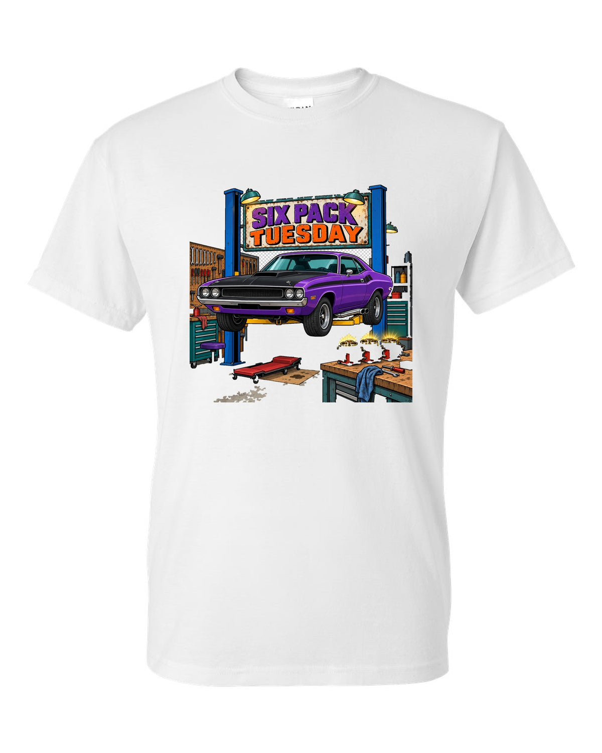 Garage workshop scene with a 1970 Dodge Challenger T/A on a lift and Six Pack Tuesday text white t-shirt front view with the design