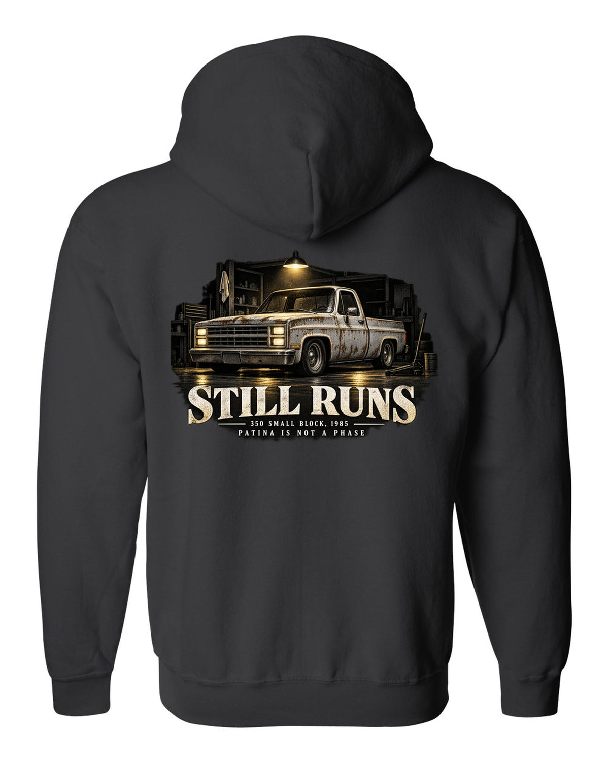 Night garage print of a 1973-87 Chevrolet C10 Squarebody with 350 small block text black zip hoodie back view with the design