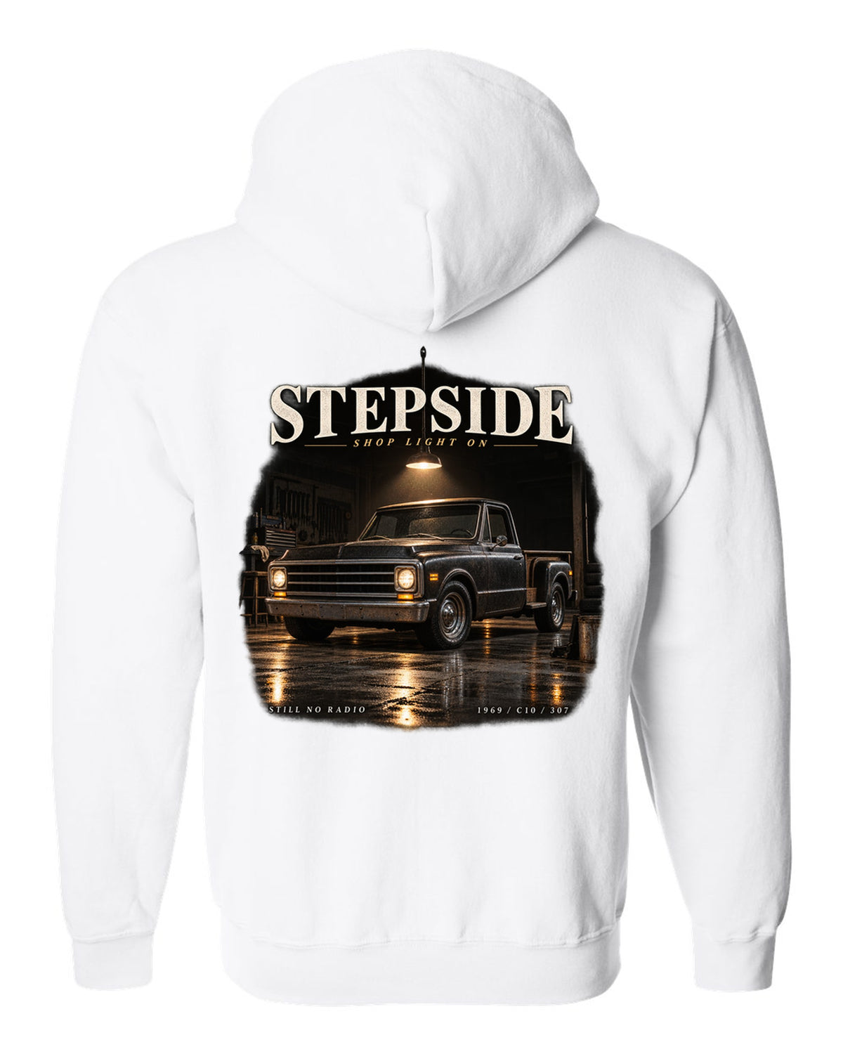 Chevy C10 Stepside under a shop light, garage night print white zip hoodie back view with the design