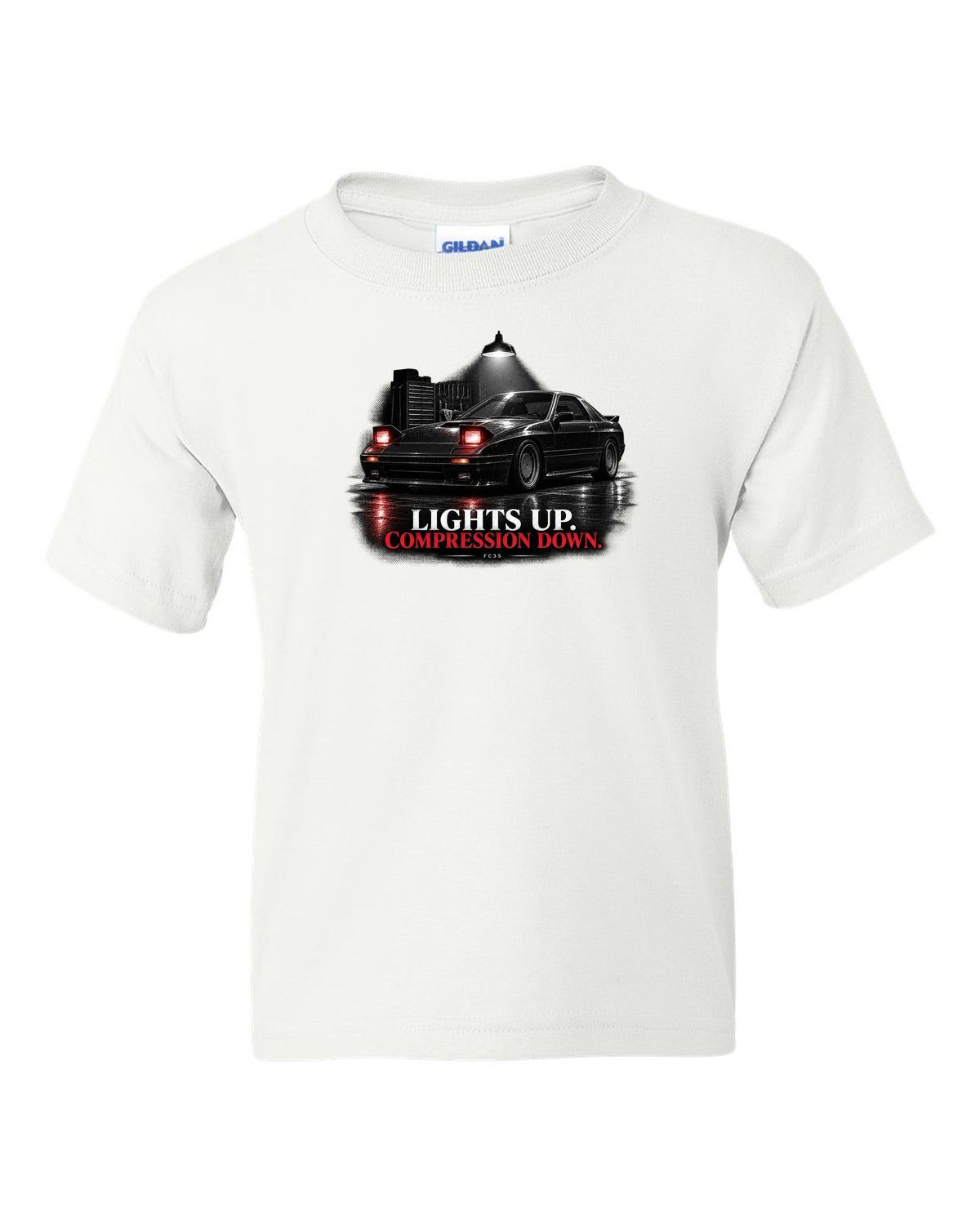Low front three-quarter Mazda RX-7 FC3S Turbo II in a garage at night white kids tee front view with the design