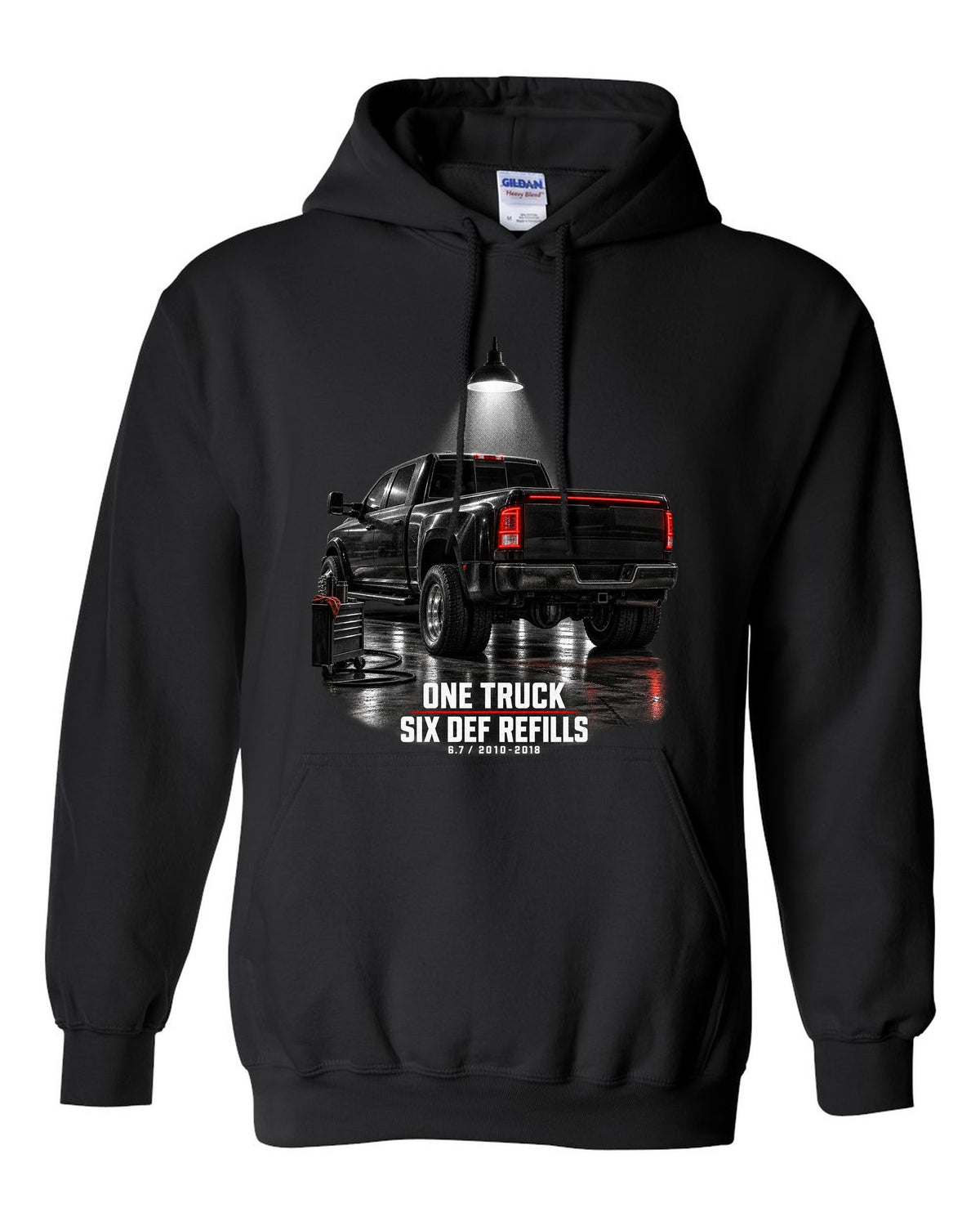 Ram 3500 4th gen dually 6.7 in a night garage with the text One truck, six DEF refills black pull over hoodie front view with the design