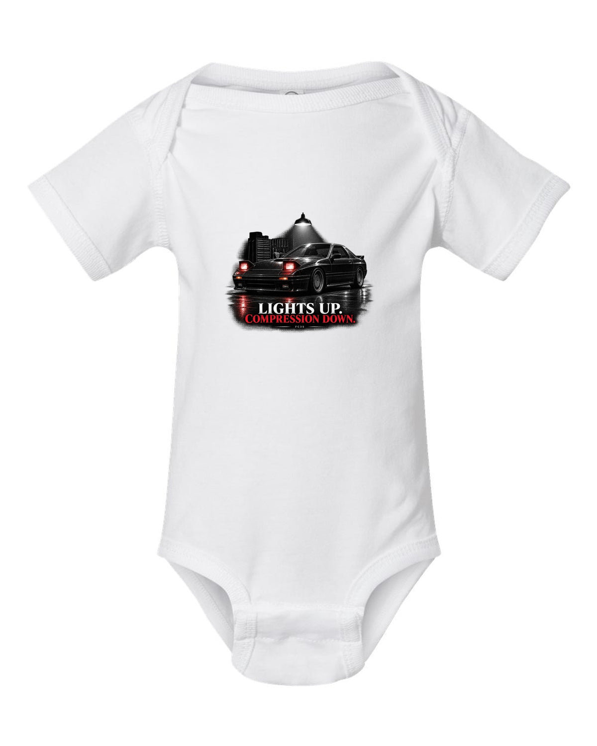 Low front three-quarter Mazda RX-7 FC3S Turbo II in a garage at night white baby onesie front view with the design