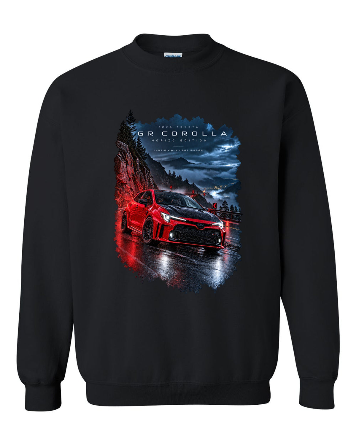 Toyota GR Corolla Morizo Edition on a wet mountain road at night black crewneck front view with the design