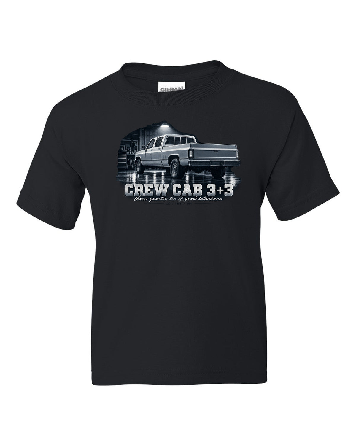1985 C20 Squarebody crew cab in a garage night scene, print black kids tee front view with the design