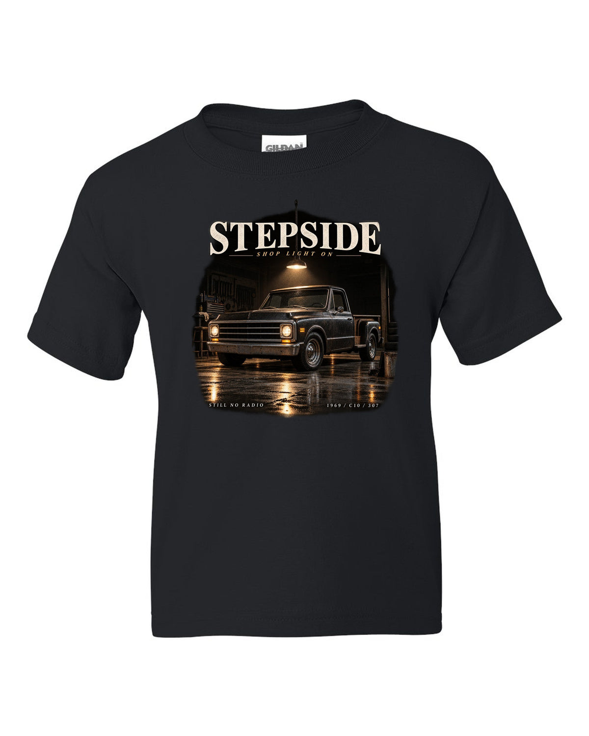 Chevy C10 Stepside under a shop light, garage night print black kids tee front view with the design