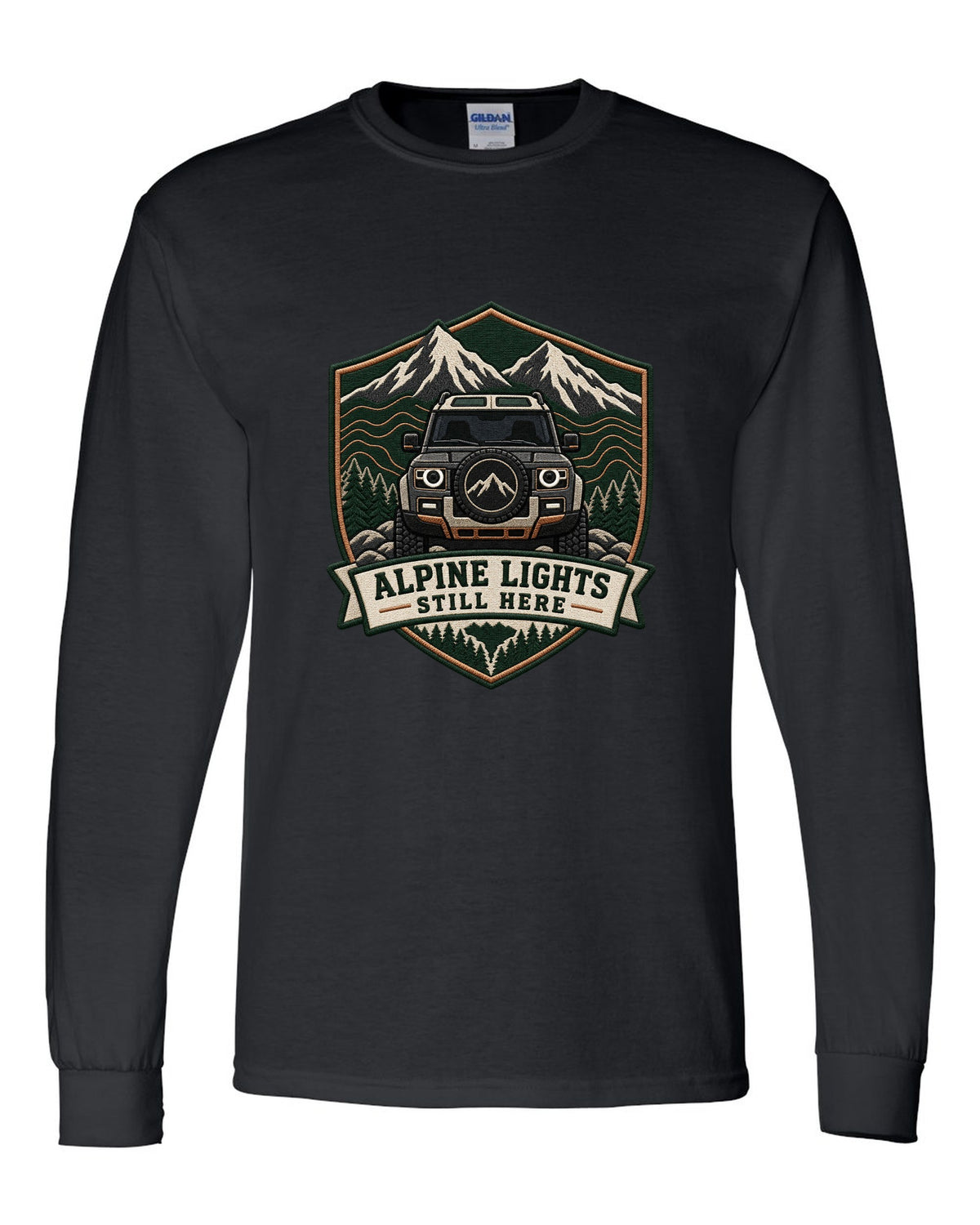 Original shield crest print for a Land Rover Defender L663 with Alpine Lights Still Here text black long sleeve front view with the design