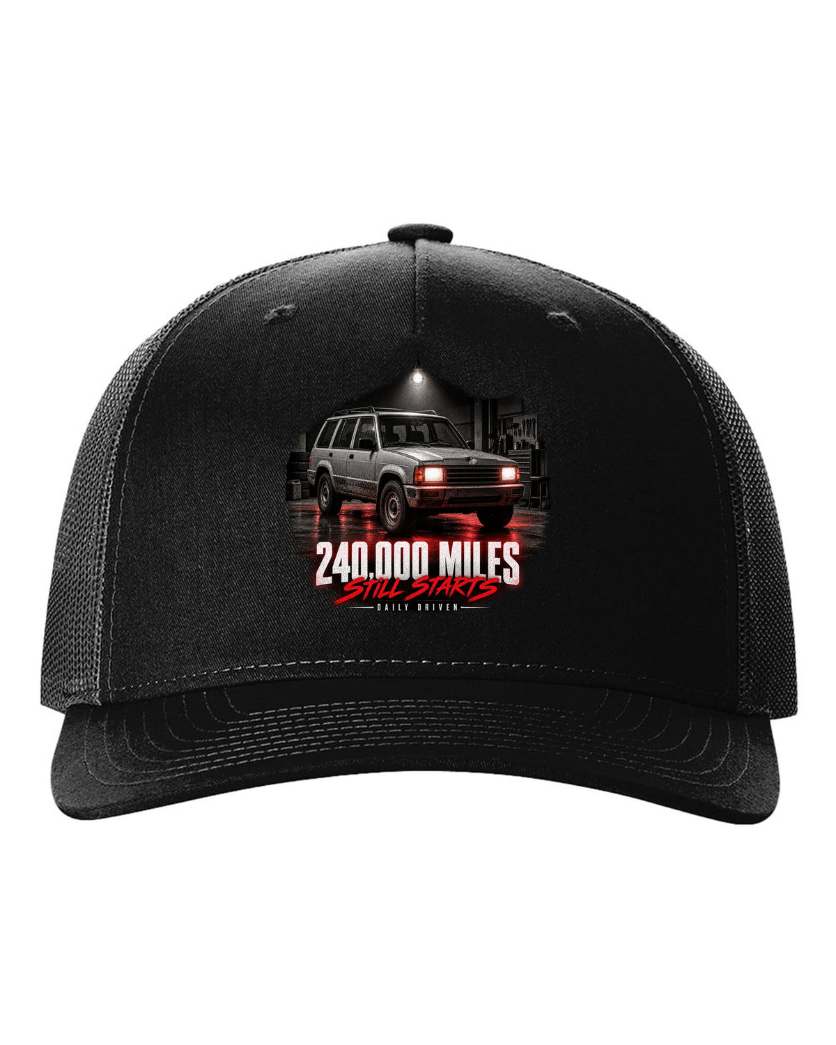 Jeep Cherokee XJ at night with daily driven 240,000 miles print black hat front view with the design