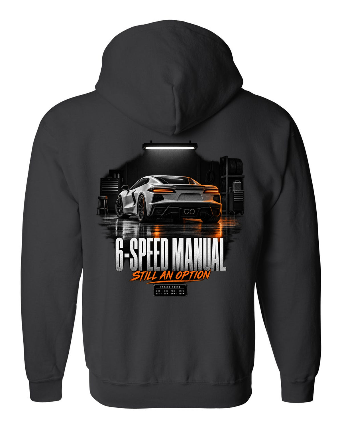 Lotus Emira V6 in a garage at night with 6-speed manual text black zip hoodie back view with the design