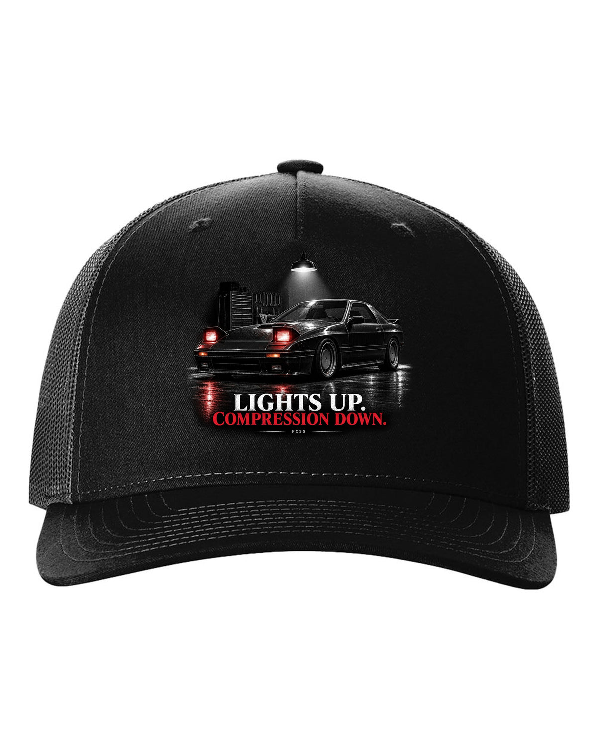 Low front three-quarter Mazda RX-7 FC3S Turbo II in a garage at night black hat front view with the design