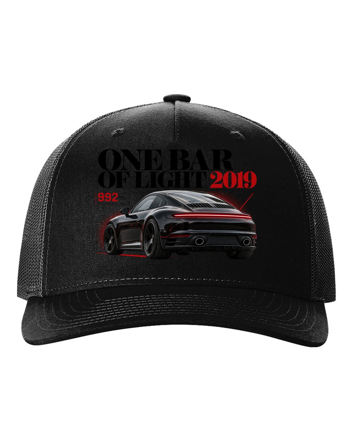 Editorial headline print of a Porsche 911 Carrera S 992 with One Bar Of Light caption black hat front view with the design