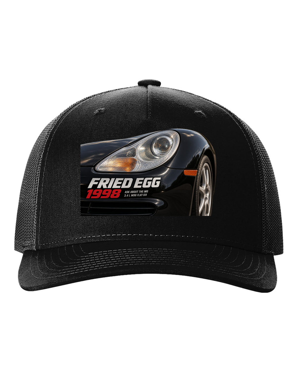 Close-up detail print of the Porsche 911 996 Fried Egg lamp with IMS joke text black hat front view with the design